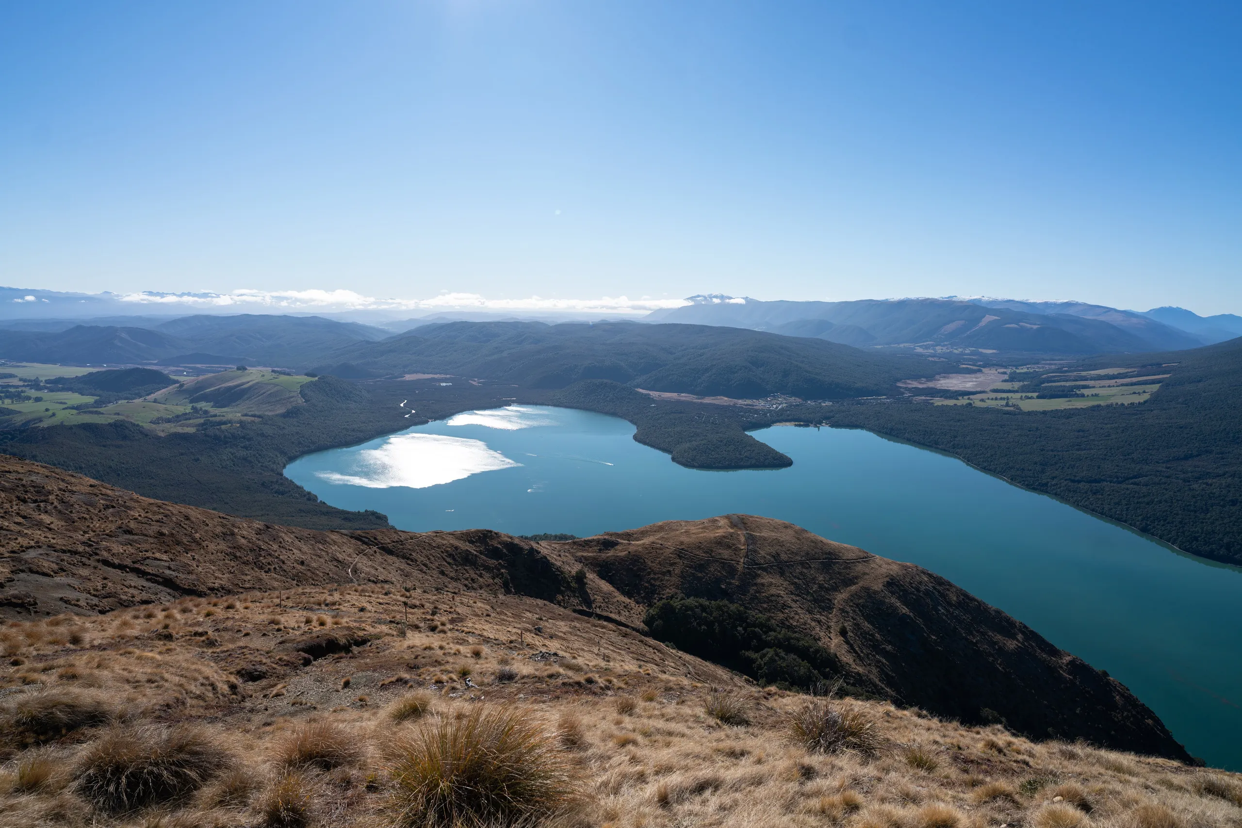 The trail climbs up high above the lake, granting panoramic views across the entire region