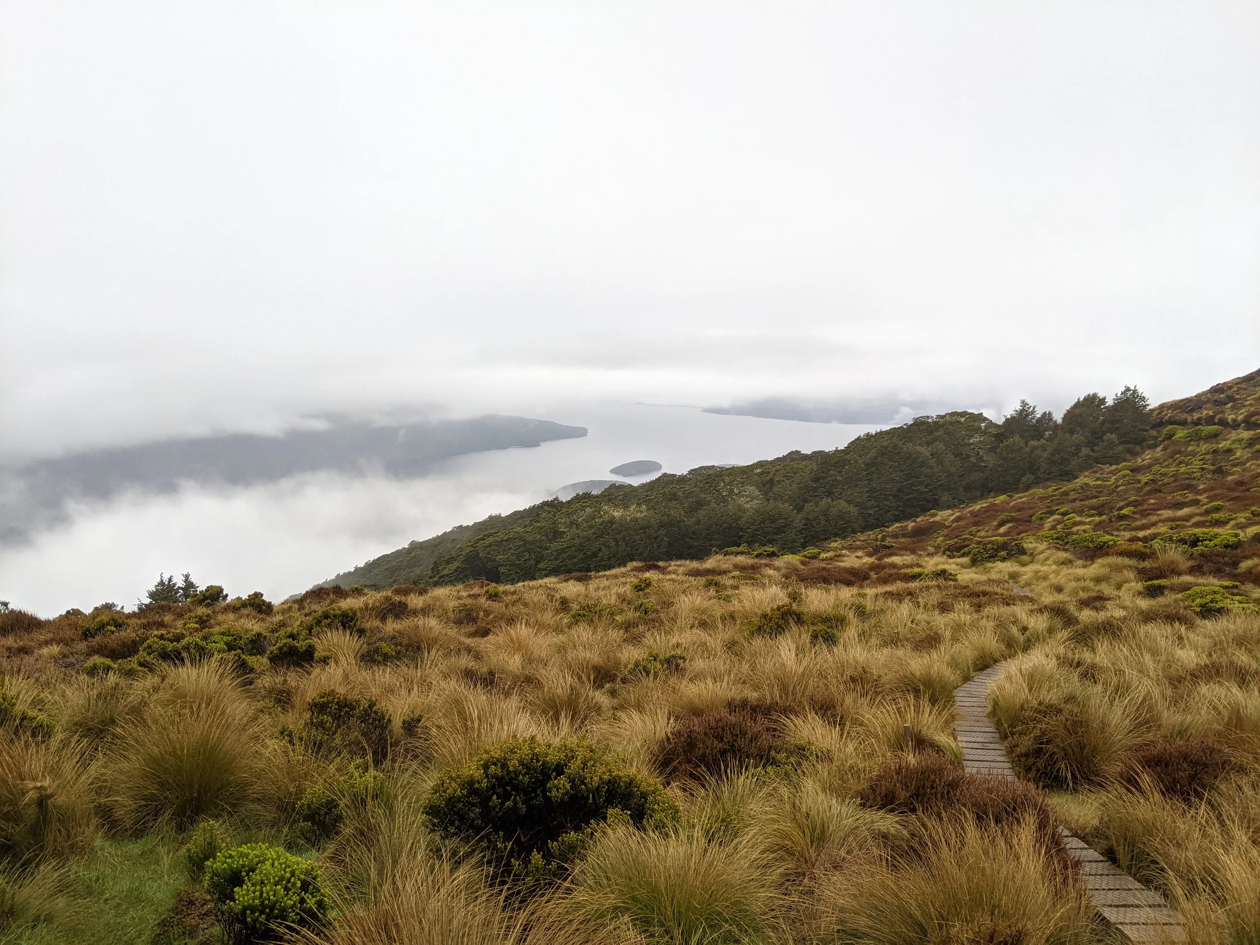 The clouds part to give a glimpse of Lake Te Anau